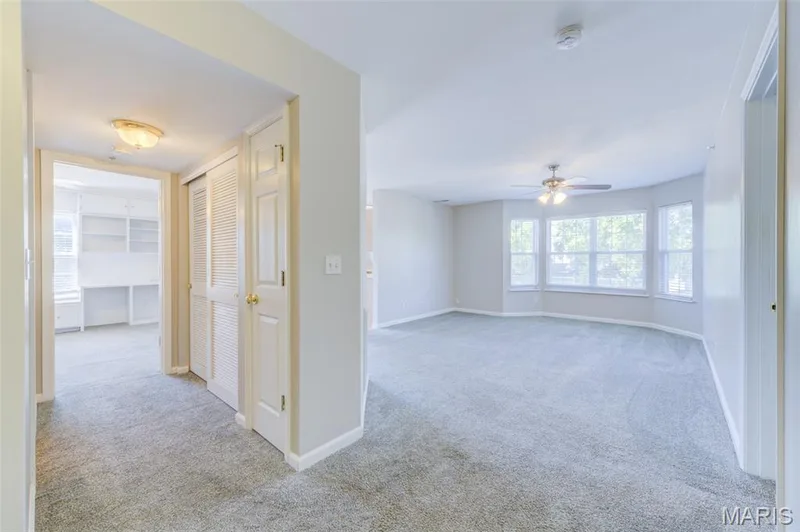 View from the entry foyer.  The living space is straight ahead and the hall bath and 2nd bedroom are to the left. Lots of light in this unit! — 480 Benton Drive #F, St Peters, MO 63376