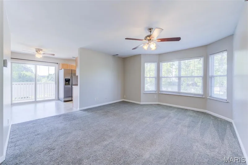 A few more steps in to the condo and you see the kitchen from the large living room. — 480 Benton Drive #F, St Peters, MO 63376