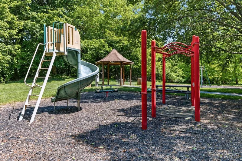 Outdoor playground area featuring a spiral slide, climbing structure, and a nearby gazebo — 480 Benton Drive #F, St Peters, MO 63376