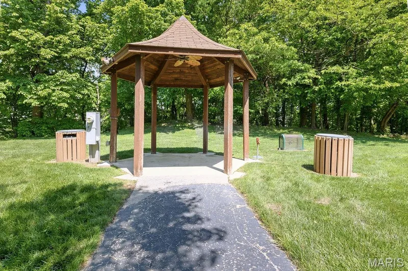 Wood-shingled gazebo with an integrated ceiling fan and concrete pad — 480 Benton Drive #F, St Peters, MO 63376