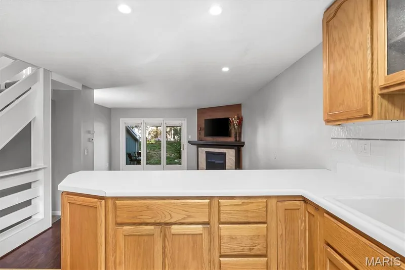 Kitchen counter with light-toned cabinetry and a white countertop — 43 Breezy Knoll Lane, Lake St. Louis, MO 63367
