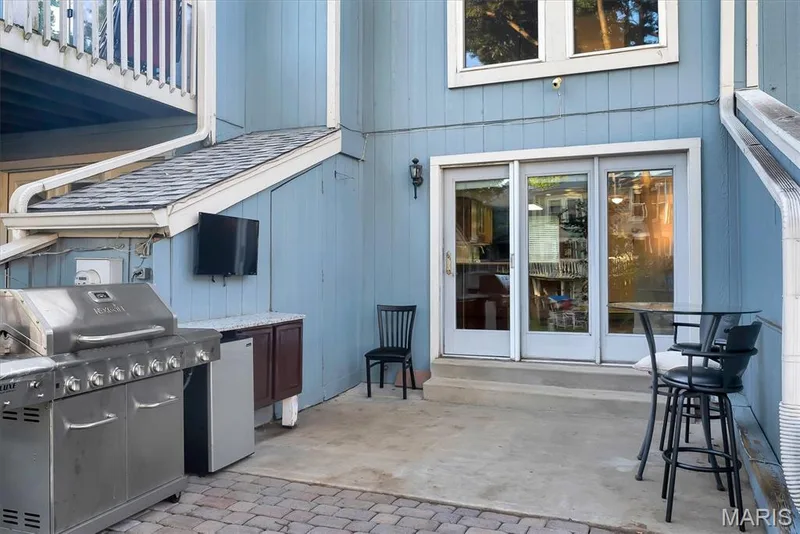 Outdoor patio arrangement with  kitchen type setup with stone-finish countertops and cabinetry — 43 Breezy Knoll Lane, Lake St. Louis, MO 63367