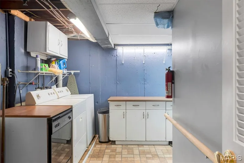 Laundry area with a washer, built-in cabinetry, and countertop space — 43 Breezy Knoll Lane, Lake St. Louis, MO 63367