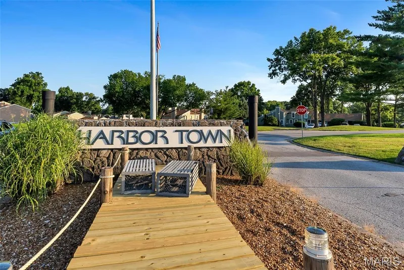 Community entrance signage featuring stone construction and integrated lettering — 43 Breezy Knoll Lane, Lake St. Louis, MO 63367