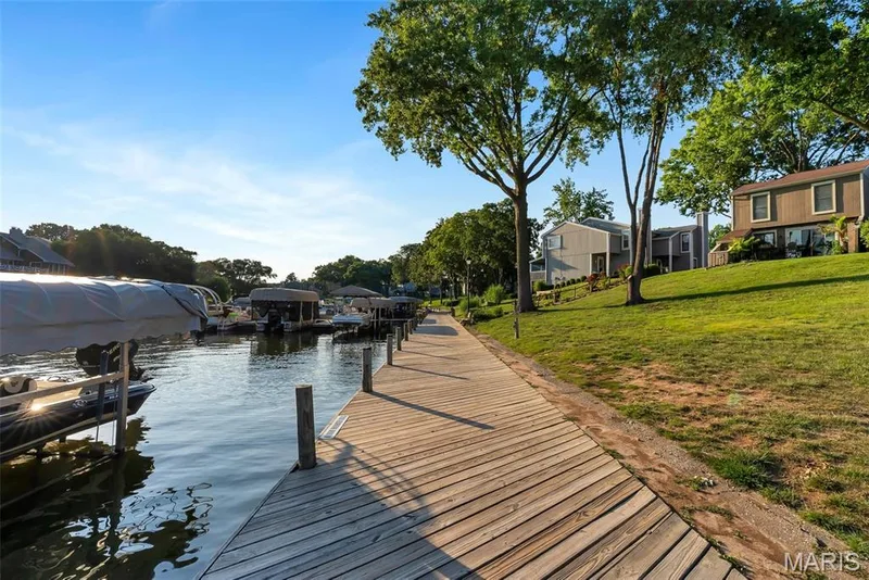 Expansive wood-finish dock spanning a waterfront setting — 43 Breezy Knoll Lane, Lake St. Louis, MO 63367