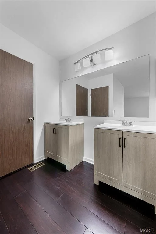 Primary bathroom with dual sinks and walk-in closet — 11 Victoria Square, St Peters, MO 63376
