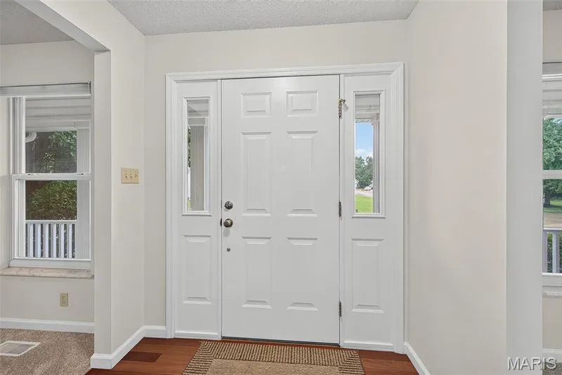 White paneled entry door with sidelights and transom window — 4014 Treeshadow Drive, St Peters, MO 63376