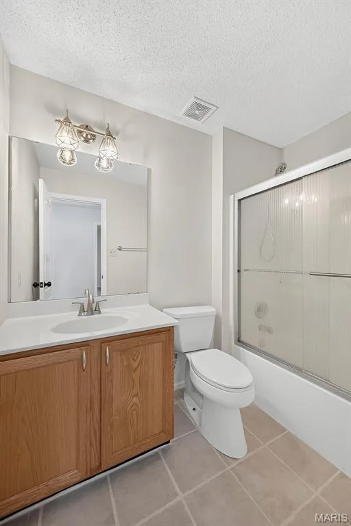 Bathroom featuring a light wood-finish vanity with an integrated sink, a white countertop, and a brushed nickel faucet — 4014 Treeshadow Drive, St Peters, MO 63376
