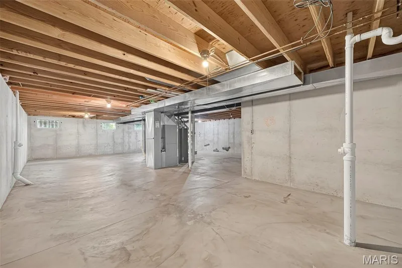 Spacious unfinished basement offering concrete flooring, concrete walls, exposed ceiling joists, and block windows — 4014 Treeshadow Drive, St Peters, MO 63376