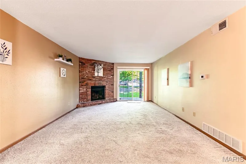 Plenty of space in the combined living & dining space with the pond outside the sliding doors. — 1440 Heritage Landing #105, St Charles, MO 63303