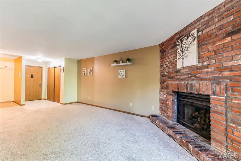 The 1,146-square-foot floor plan features an open living and dining area with a gas fireplace (never used by the seller). — 1440 Heritage Landing #105, St Charles, MO 63303
