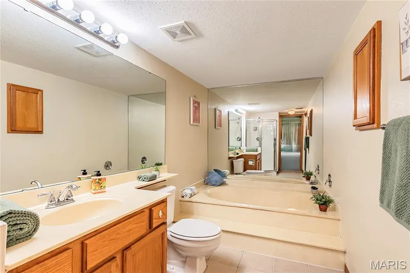 Spacious primary bathroom with a soaking tub you'll never want to leave — 1440 Heritage Landing #105, St Charles, MO 63303
