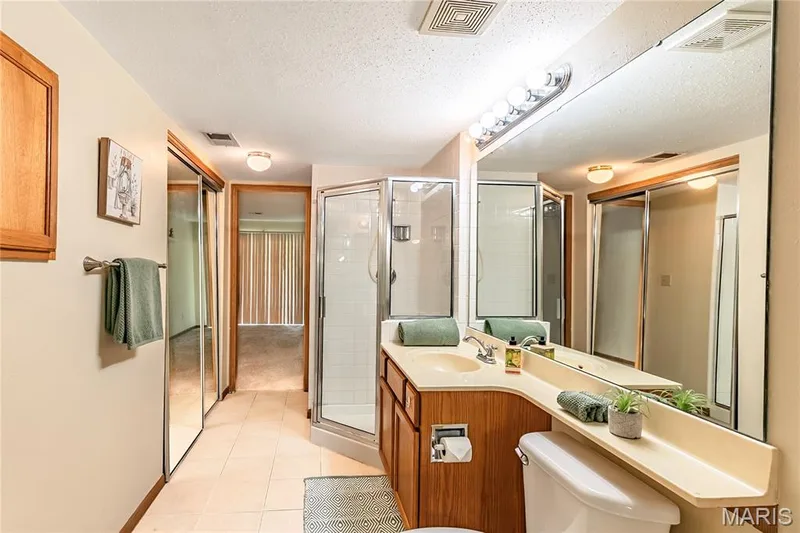Primary bathroom also includes a separate shower and another closet! — 1440 Heritage Landing #105, St Charles, MO 63303