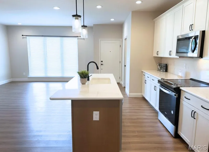 Kitchen With Solid Surface Counters, Soft Close Cabinets, Deluxe Lighting Package, Stainless Steel Appliances, & Refrigerator — 2810 McClay Road, St Charles, MO 63303