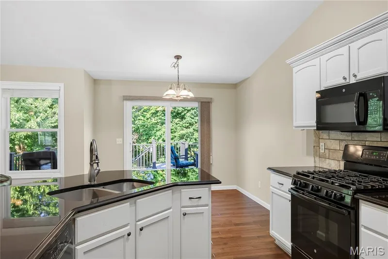 Gas Range and Above the Range Microwave in Kitchen — 167 Rightfield Drive, O'Fallon, MO 63366