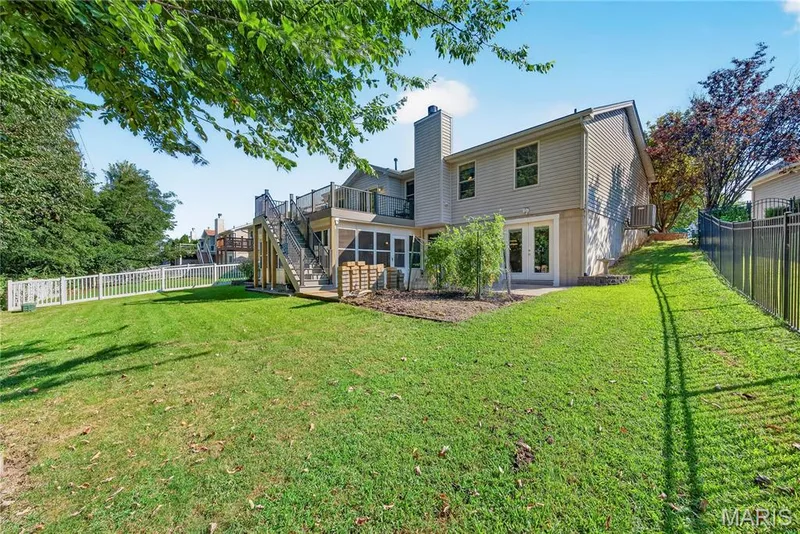 Walk Out Rear Elevation with Patio, Sunroom/ Screened in Porch and Composite Deck with Steps to Yard — 167 Rightfield Drive, O'Fallon, MO 63366
