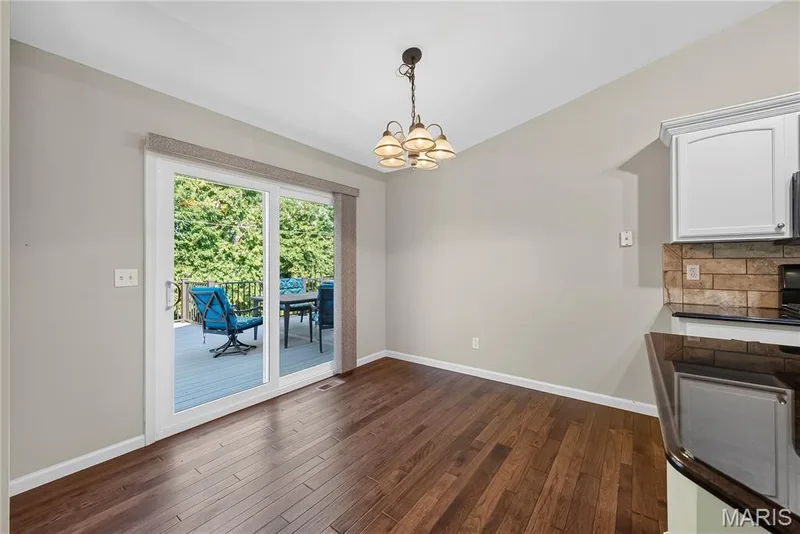 Breakfast Room with Vaulted Ceilings, Wood Flooring and Sliding Glass Door opening to Composite Deck — 167 Rightfield Drive, O'Fallon, MO 63366