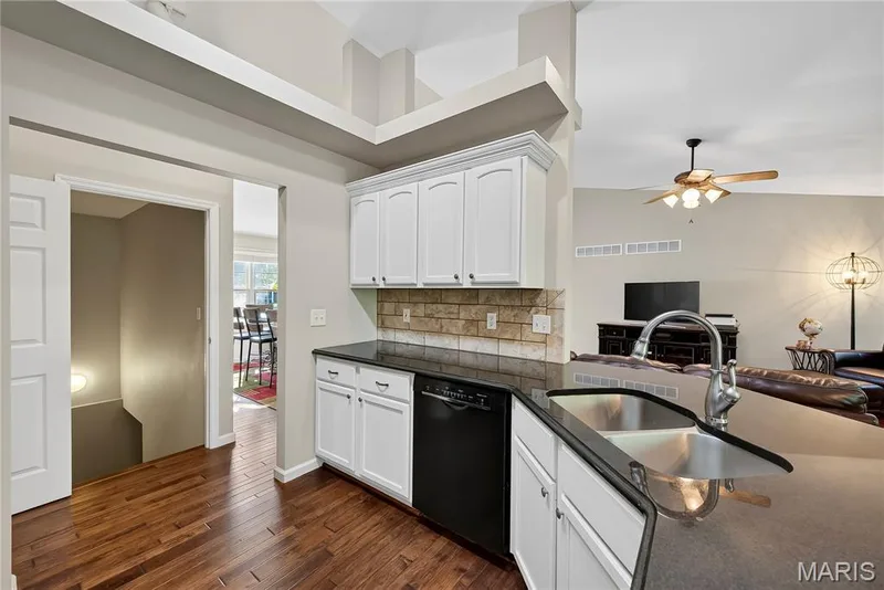Kitchen with Vaulted Ceilings, Wood Flooring, Granite Countertops and Tile Backsplash — 167 Rightfield Drive, O'Fallon, MO 63366