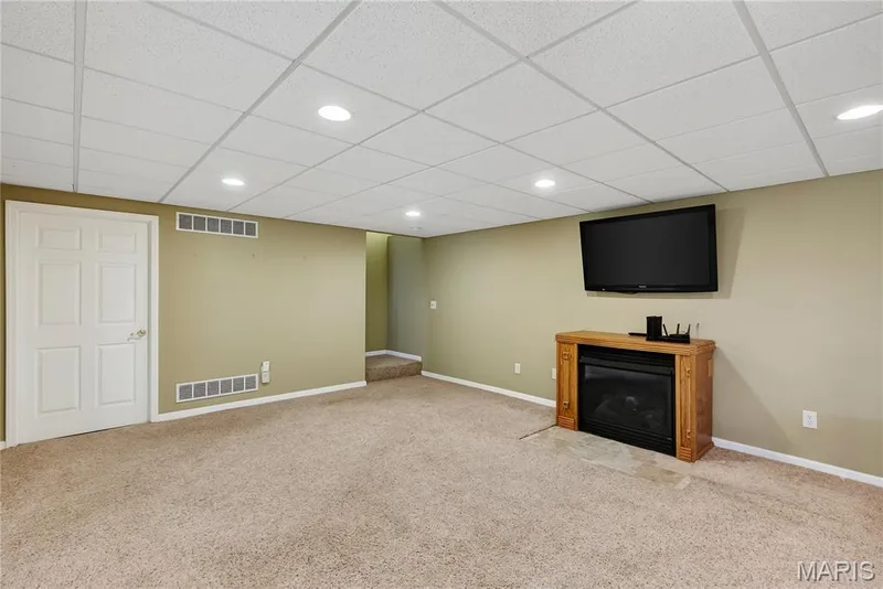 Family Room with Gas Fireplace in Finished Lower Level — 167 Rightfield Drive, O'Fallon, MO 63366