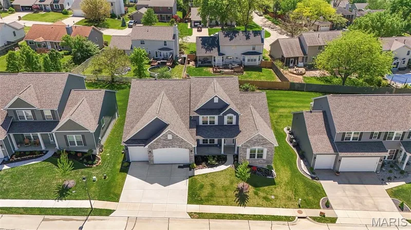 Modern residence featuring a gray and stone facade with multiple gables — 365 Kreder Ridge Circle, St Charles, MO 63304