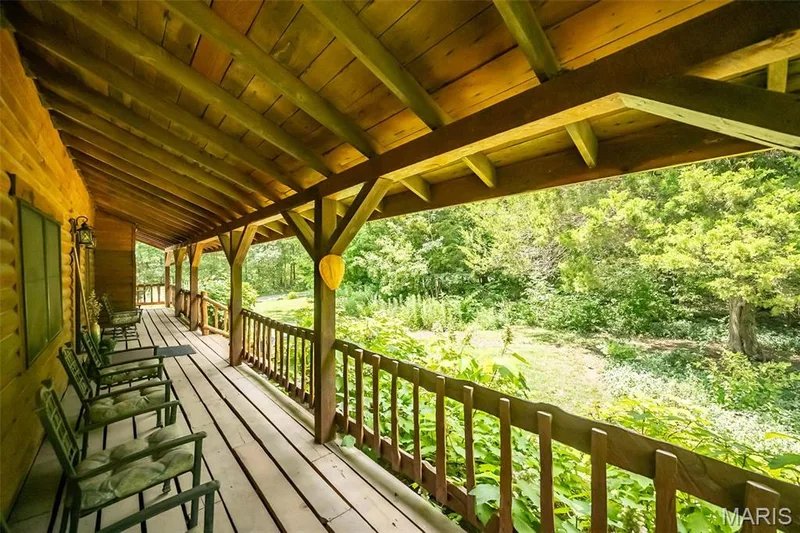 Front deck with a covered roof that extends the entire length of the home — 8 Whippoorwill Court, Defiance, MO 63341