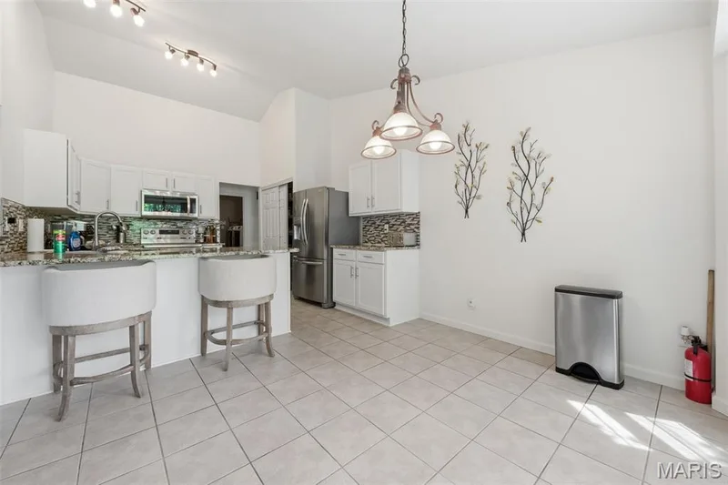 Large kitchen with Granite tops and breakfast bar seating — 214 Charging Bear Drive, Wentzville, MO 63385