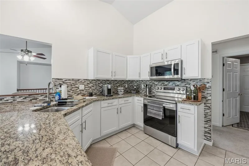 Large kitchen has ample granite top space and Stainless steel appliances — 214 Charging Bear Drive, Wentzville, MO 63385