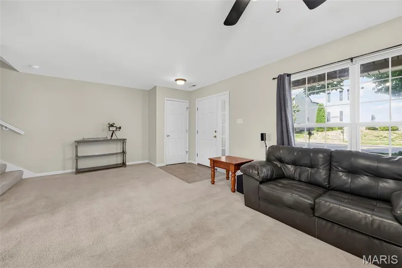 Living area featuring light-colored carpeting and neutral wall paint — 916 Carpathian Drive, Lake St. Louis, MO 63367