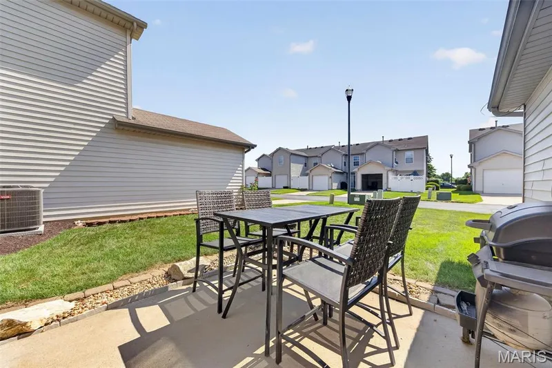 Concrete patio with a stone border and a grassy yard — 916 Carpathian Drive, Lake St. Louis, MO 63367