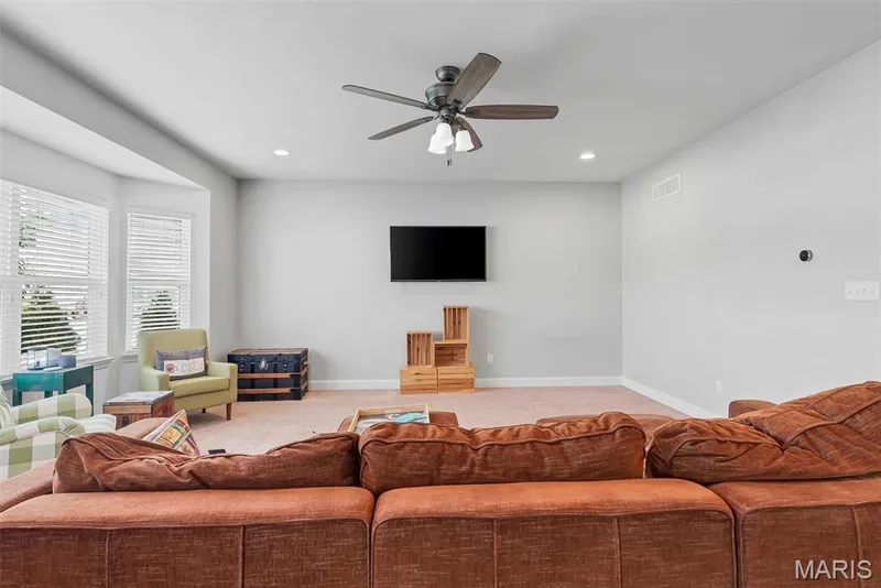 Spacious room featuring a bay window, recessed lighting, and a ceiling fan — 225 Thorn Brook Drive, O'Fallon, MO 63366