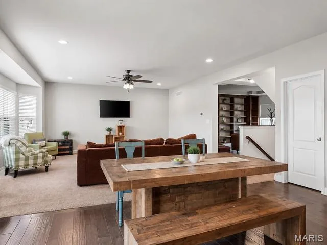 Wood-finish flooring, recessed lighting, ceiling fan, white paneled door, and built-in shelving — 225 Thorn Brook Drive, O'Fallon, MO 63366
