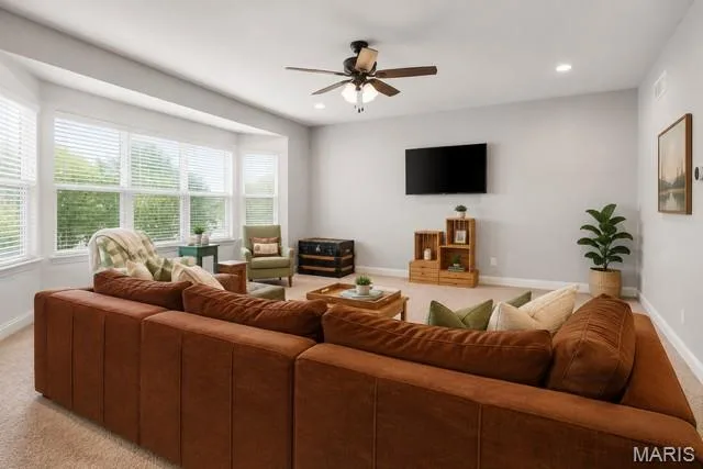 Bay window with multiple panels, ceiling fan with integrated lighting, recessed lighting, wall-mounted television, and neutral carpeting — 225 Thorn Brook Drive, O'Fallon, MO 63366