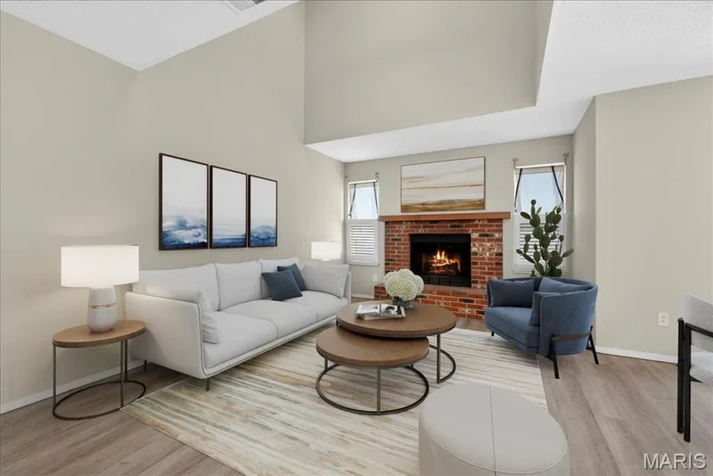 Two story living room with a wood-burning fireplace — 352 Windsor Place #B, St Peters, MO 63376