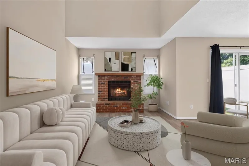 Two story living room with a wood-burning fireplace — 352 Windsor Place #B, St Peters, MO 63376