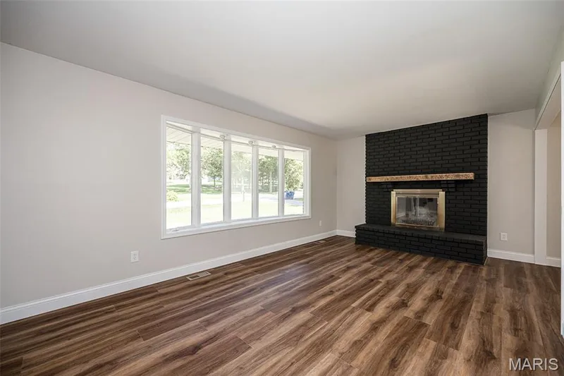 Living room with new laminate flooring — 5935 Lafayette Drive, Weldon Spring, MO 63304