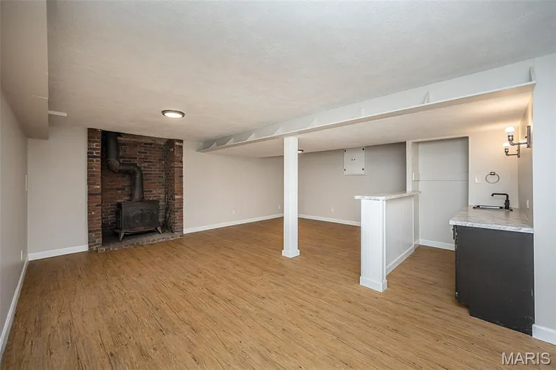 lower level family room with wood stove and wet bar — 5935 Lafayette Drive, Weldon Spring, MO 63304