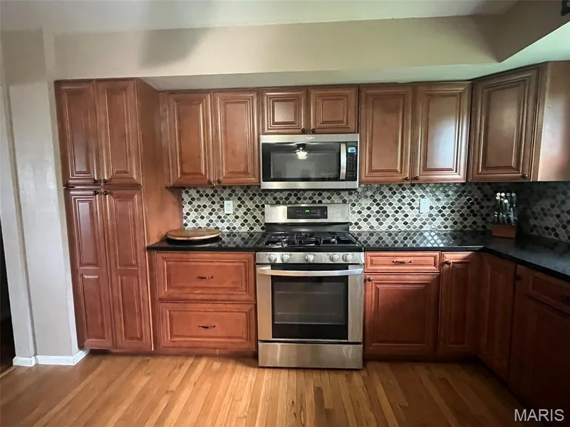 Pretty Tile backsplash, Pantry closet to the left and corner turn shelving to the right — 2701 Headland Drive, St Charles, MO 63301