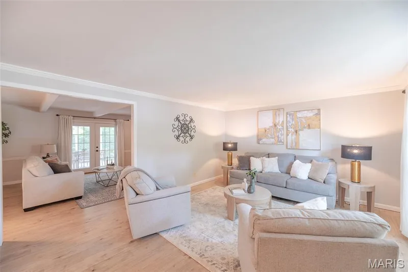Expansive living area featuring light-toned walls and wood-finish flooring — 1526 Candish Lane, Chesterfield, MO 63017