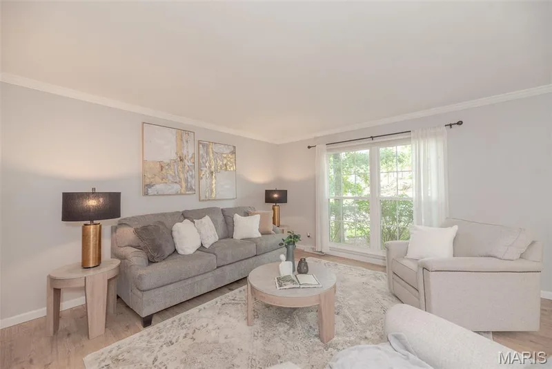 Light-toned wall finish, expansive window, crown molding, and light wood-finish flooring — 1526 Candish Lane, Chesterfield, MO 63017