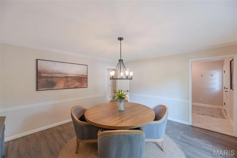 Wood-finish flooring, crown molding, and chair rail detailing — 1526 Candish Lane, Chesterfield, MO 63017