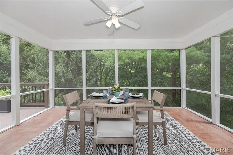 Screened porch with wood-finish flooring, white ceiling, and a ceiling fan with integrated lighting — 1526 Candish Lane, Chesterfield, MO 63017