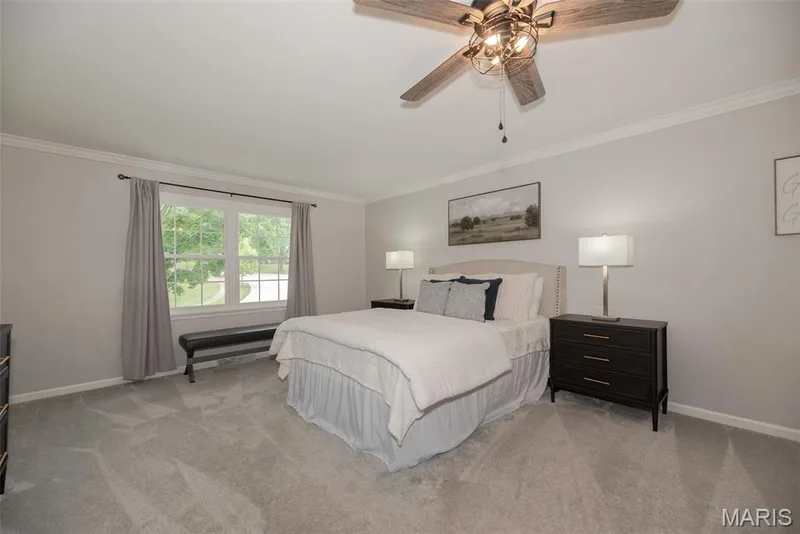 Recessed window with white trim, crown molding, ceiling fan with integrated lighting, and carpeted flooring — 1526 Candish Lane, Chesterfield, MO 63017