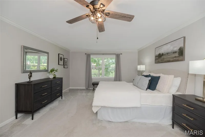 Recessed window with natural light, crown molding, ceiling fan with light fixture, carpeted flooring, and neutral wall tones — 1526 Candish Lane, Chesterfield, MO 63017