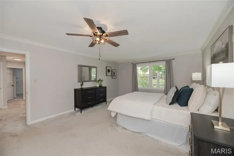 Spacious room with crown molding, a ceiling fan with light, and a window with natural light — 1526 Candish Lane, Chesterfield, MO 63017