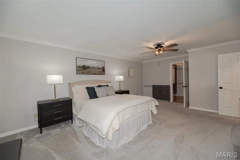 Neutral wall paint with crown molding, ceiling fan with light fixture, light gray carpet, and white paneled doors — 1526 Candish Lane, Chesterfield, MO 63017