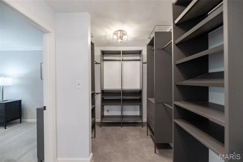 Custom closet system featuring multiple shelves, hanging rods, and built-in drawers — 1526 Candish Lane, Chesterfield, MO 63017