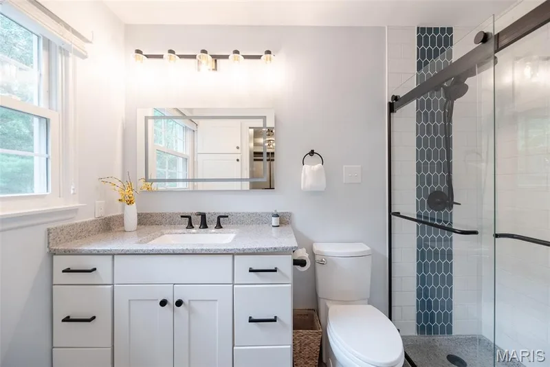 White vanity with dark hardware, undermount sink, and light-toned countertop — 1526 Candish Lane, Chesterfield, MO 63017