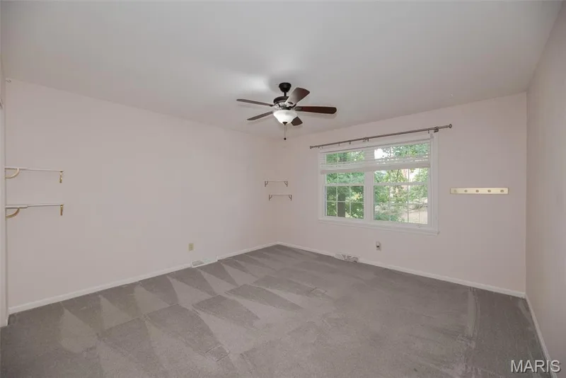 Recessed window with white trim, wood-finish ceiling fan with integrated lighting, and neutral wall tones — 1526 Candish Lane, Chesterfield, MO 63017
