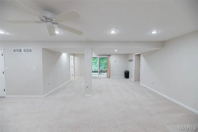 Expansive carpeted room featuring recessed lighting, a ceiling fan, and sliding glass doors — 1526 Candish Lane, Chesterfield, MO 63017