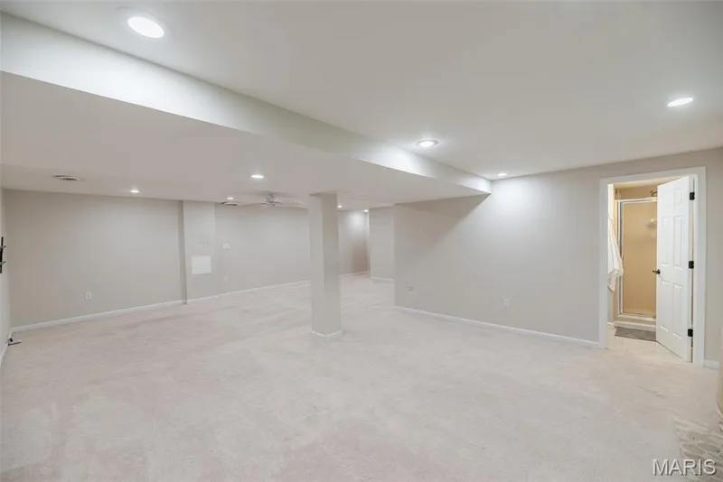 Recessed lighting throughout, neutral carpeting, light-toned walls, ceiling fan, and a full bathroom with a walk-in shower — 1526 Candish Lane, Chesterfield, MO 63017